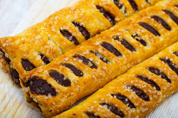 Closeup of sweet chocolate tronquito - crispy puff pastry with chocolate filling sprinkled with...