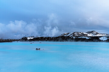 Unique landscape with lava fields and blue thermal water in Iceland. Outside Blue Lagoon in Iceland. The blue water between the lava stones. Hot springs Blue Lagoon in Iceland.