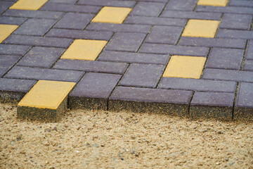 laying paving slabs in a city street, pavement tile closeup