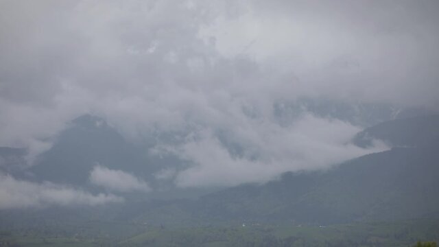 Heavy clouds over the Bucegi mountains in Romania during a spring day, as seen from the hills of Pestera village.