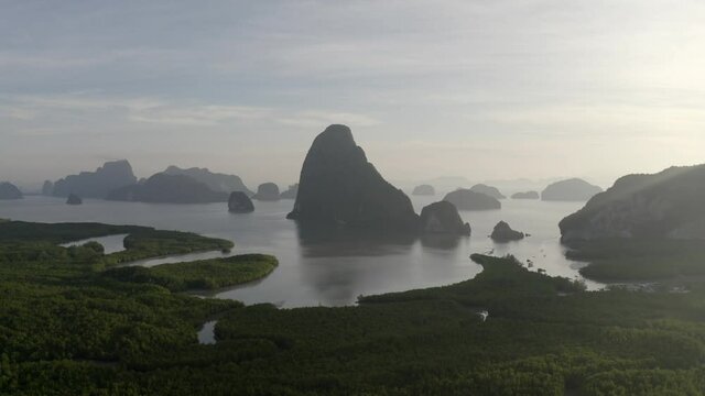Drone shot during sunrise of the mountains and lake at Thailand