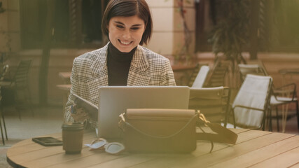 Fototapeta premium Attractive businesswoman talking with colleagues by video call u