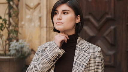 Attractive businesswoman dressed in blaizer and turtleneck sweat