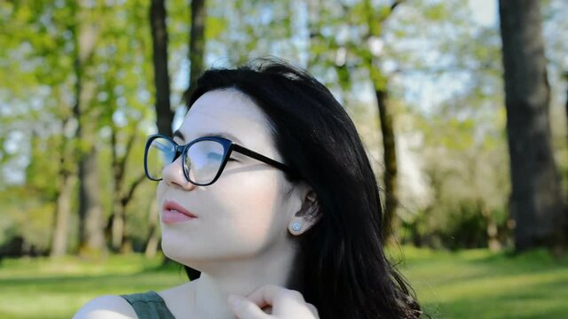Beautiful brunette girl in glasses and white skin portrait
