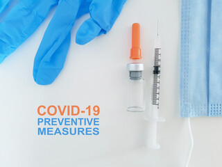 Fototapeta premium Covid-19 Coronavirus Prevention Measures with glove, vaccine vial, syringe and surgical face mask