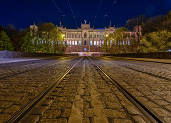 Low perspective symmetrical view over a tram track with popular Munich architecture in the...