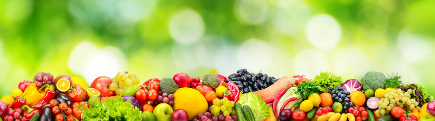 Horizontal seamless pattern from healthy fruits, vegetables and berries on gree