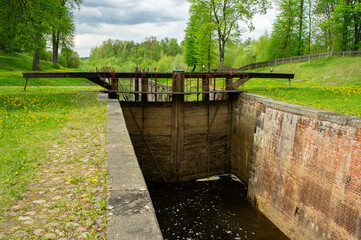 Old navigable river sluice. 20th century architecture with wooden mechanics. Augustow Canal,...