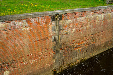 Old vintage brick wall of a river sluice