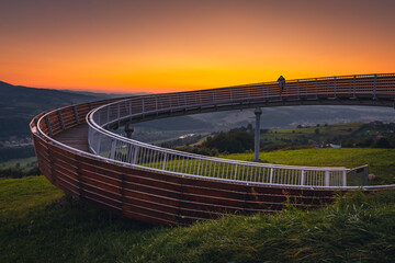 Picturesque sunset in Beskid Sądecki seen from the tower in Wola Krogulecka, with views of the mountains and fields. © PawelUchorczak