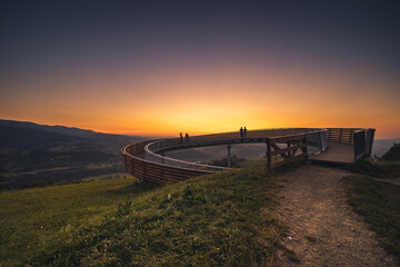 Picturesque sunset in Beskid Sądecki seen from the tower in Wola Krogulecka, with views of the mountains and fields.