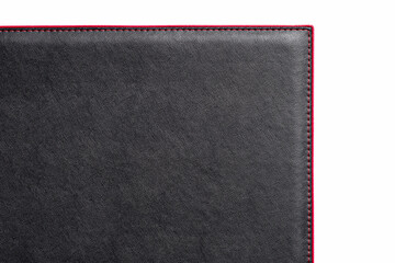 Black fine texture of genuine leather. Close-up edge. Scarlet threds