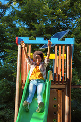  African American woman having fun on playground.