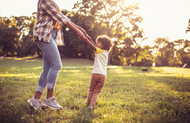 Fototapeta premium African American mother and daughter playing in park.