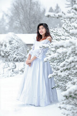 Fototapeta na wymiar Biracial teen girl with white dress outside in snow