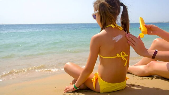 baby maje sunscreen on the beach. selective focus.