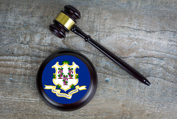 Wooden judgement or auction mallet with of Connecticut flag. Conceptual image.