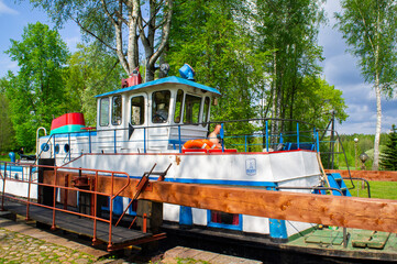 Fototapeta na wymiar Old vintage navigable river motor ship. Augustow Canal, Belarus, 18 May 2021
