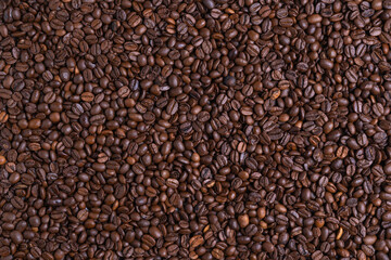 Roasted black coffee beans background. Top view