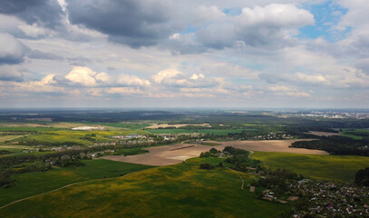 Fototapeta na wymiar View from the sky to the summer landscape with fields and sky for background