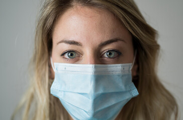 Doctor or nurse wearing scrubs and protective medical face mask. Medicine and health care workers