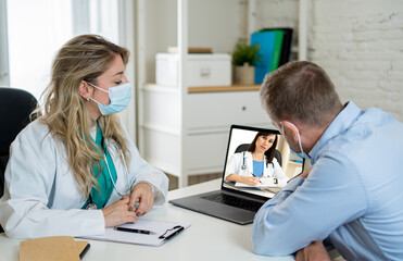 Female doctor and male patient on video conference having an online consultation with specialist