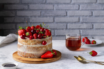 Bright summer cake with fresh berries on the table