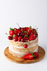 Summer cake decorated with berries on a white background