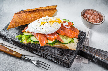 Sandwich with Poached egg, smoked salmon and avocado on toast.  White background. Top view