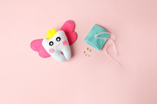 Tooth fairy with magic wings and crown on pink background, greeting card with copy space Happy Tooth Fairy Day on February 28th or 22 august, healthcare, kids oralcare concept, banner, flyer