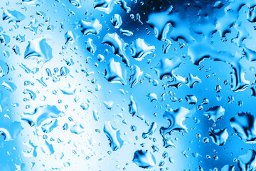 Rain window background. Water drops background. Wet glass surface texture. Bubble dew pattern. Transparent window blue raindrops. Bright white environment condensation texture.