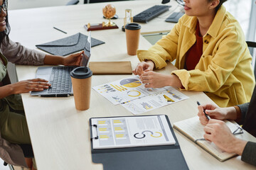 Group of business people sitting at the table with documents during a business meeting