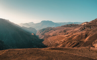 Sunset view of winding road in high mountain pass.