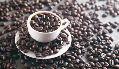 Cup of coffee on coffee beans.