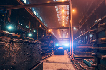 Factory interior. Heavy metallurgy industry. Foundry workshop. Steel Mill industrial plant. Metal manufacture. Large industrial building inside with metalwork equipment.