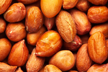 micro Close-up of organic red-brown peanuts (Arachis hypogaea) Full Frame Background. Top View
