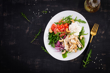 Healthy vegetable summer salad, fresh vegetables and chicken breast with yogurt dressing. Keto, ketogenic diet. Top view, above, copy space