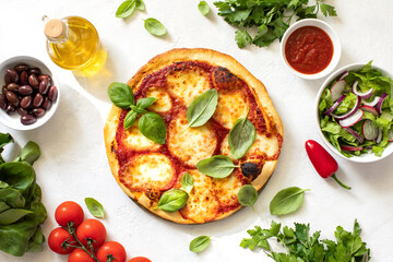 Fototapeta na wymiar Home-baked Italian pizza Margherita top-down view
