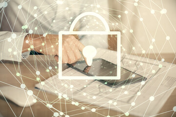 Multi exposure of man's hands holding and using a digital device and lock drawing. Security concept.