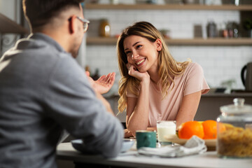 Beautiful young woman enjoying in breakfast with her husband. Husband and wife enjoying in the morning