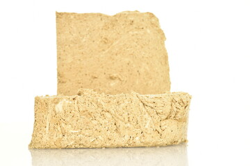 Two slices of vanilla halva, close-up, isolated on white.