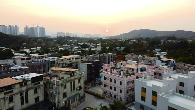 Sunset Drone Fly over Village House Hong Kong rural area. 4k Ariel footage showing village behind mountain