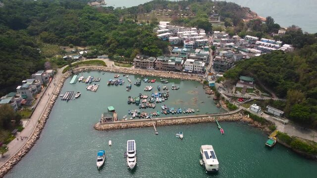 Drone Dolly push in Cheung Chau Island, Hong Kong. 4k HD footage revealing fishing boat pier, private yacht and traditional village house.