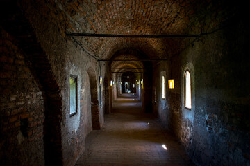 Obraz premium Long brick corridor inside an old medieval castle.