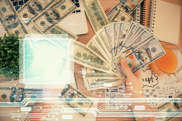 Multi exposure of technology drawing hologram and us dollars bills and man hands. Data concept