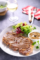 grilled beef steak with sauce and lettuce