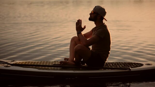 Tourist Meditation Pose Sup Board On Vacation.Standup Paddle Board.Cross-Legged No Stress Leisure Surfing Boat Fitness Workout.Travel Water Tourism Holiday Vacation Meditation.Sport Recreation Sup Fun