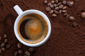 Cup of coffee on coffee background