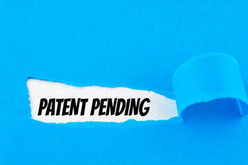 Text Patent Pending appearing behind ripped blue paper.