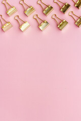 Paper binder clips. Stationery and office supplies background.